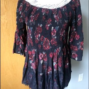 Red roses and black laced women’s top with elastic bodice.